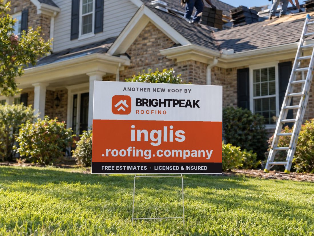 inglis.roofing.company on a yard sign in front of a house getting a new roof